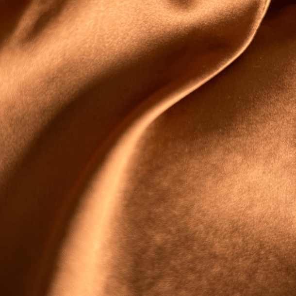 Close-up of brown silk fabric with a luxurious soft texture