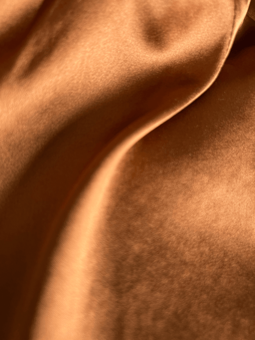 Close-up of brown silk fabric with a luxurious soft texture