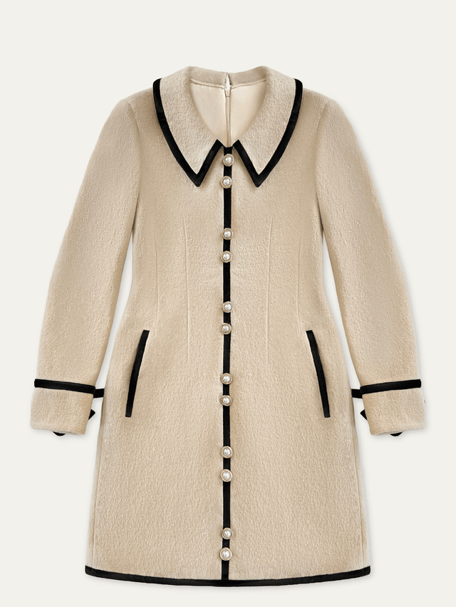 Beige wool mini dress with black trim and gold and pearl buttons on a white background